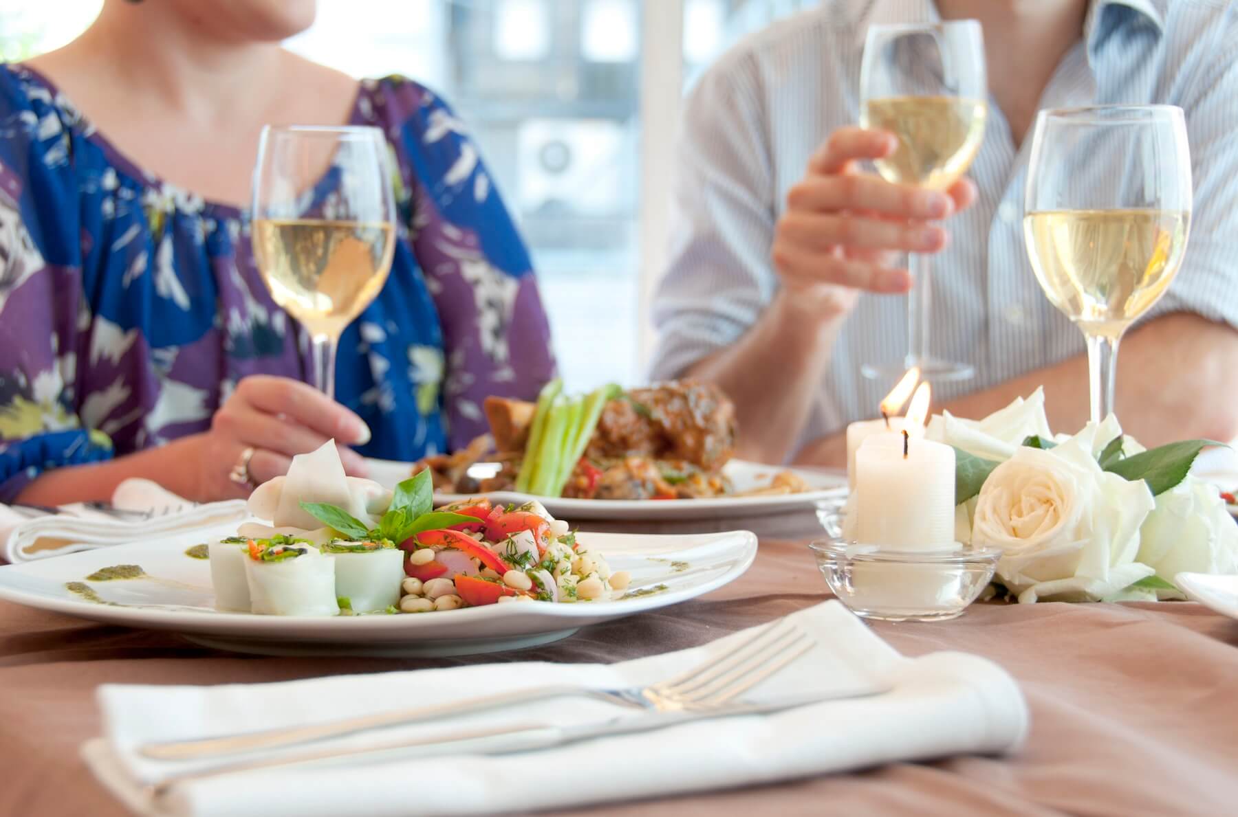 couple eating and drinking wine at one of the romantic restaurants in North Myrtle Beach