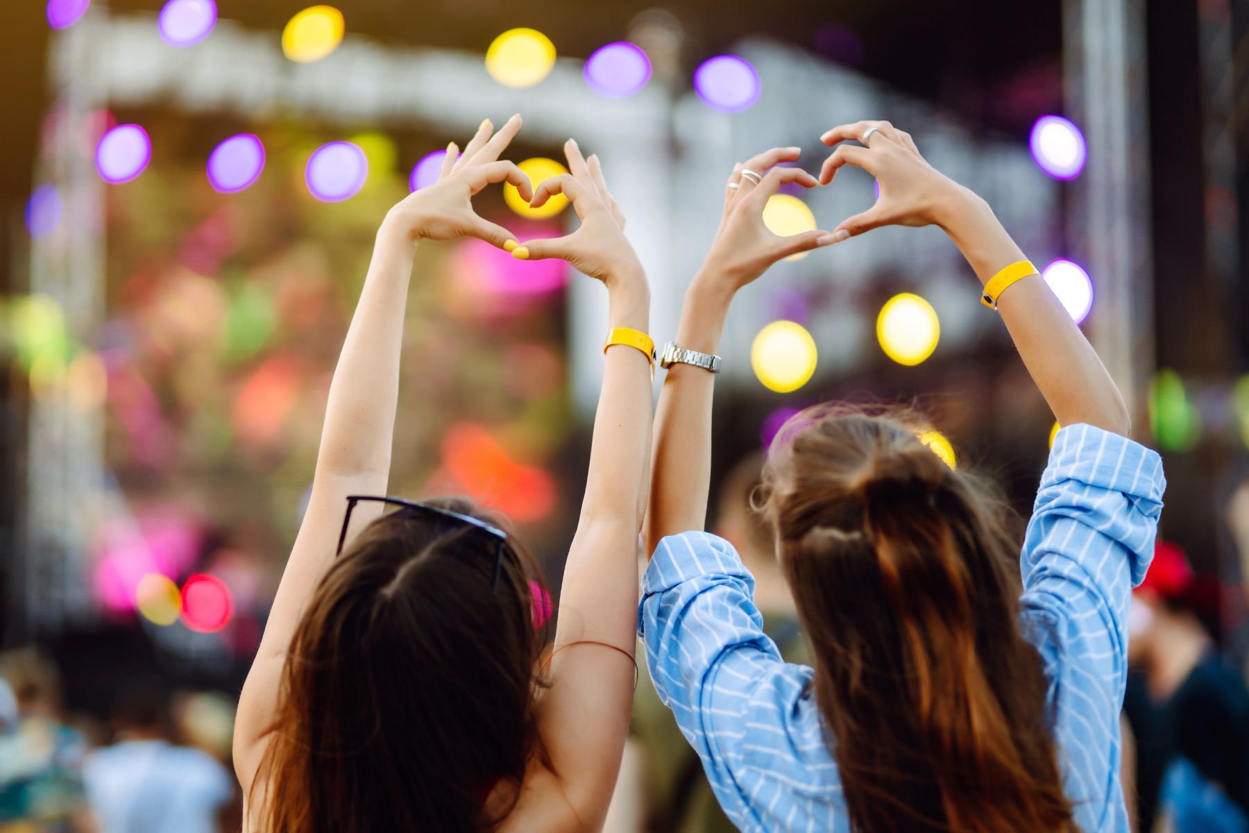 two women with heart shaped hands at the summer concert series